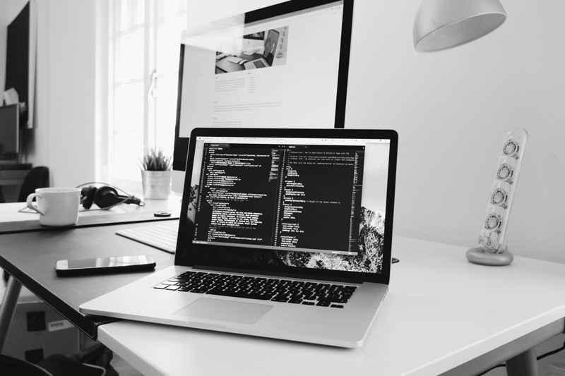 laptop on desk with dashboard for webmaster services