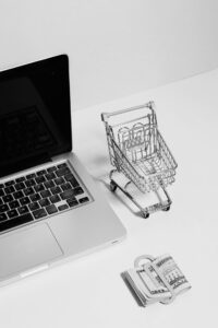 shopping cart, computer, and money representing web design cost charlotte nc